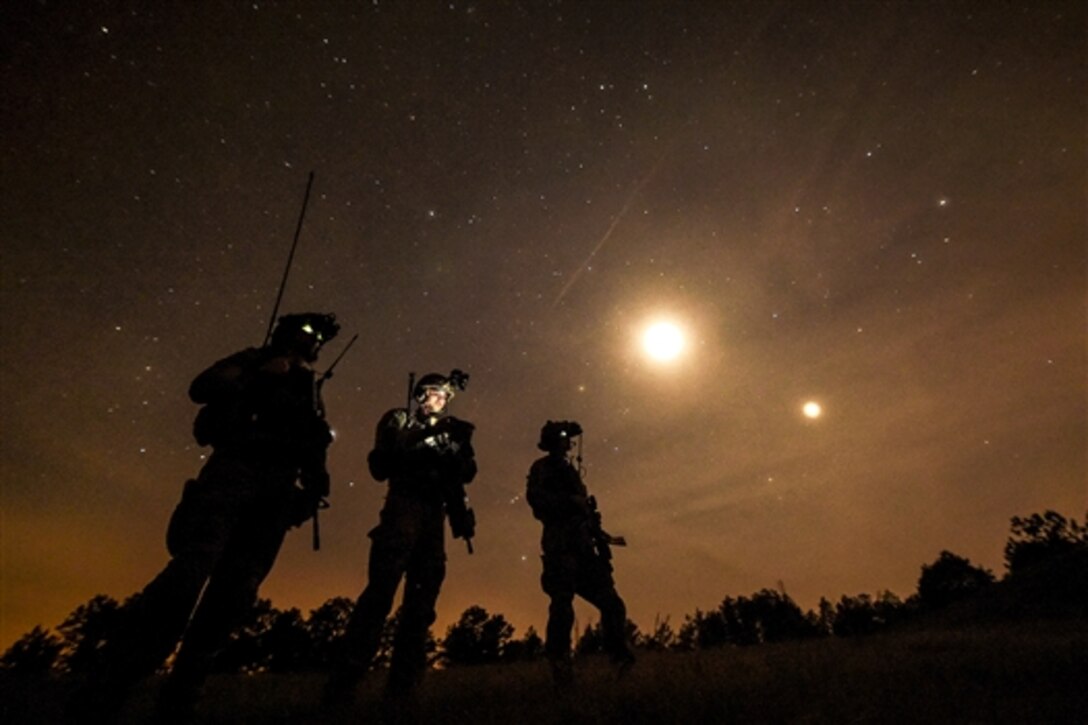 Air Force combat controllers observe an AC-130 gunship conducting a live-fire mission during Emerald Warrior on Camp Shelby, Miss., April 22, 2015. The controllers are assigned to the 21st Special Tactics Squadron.