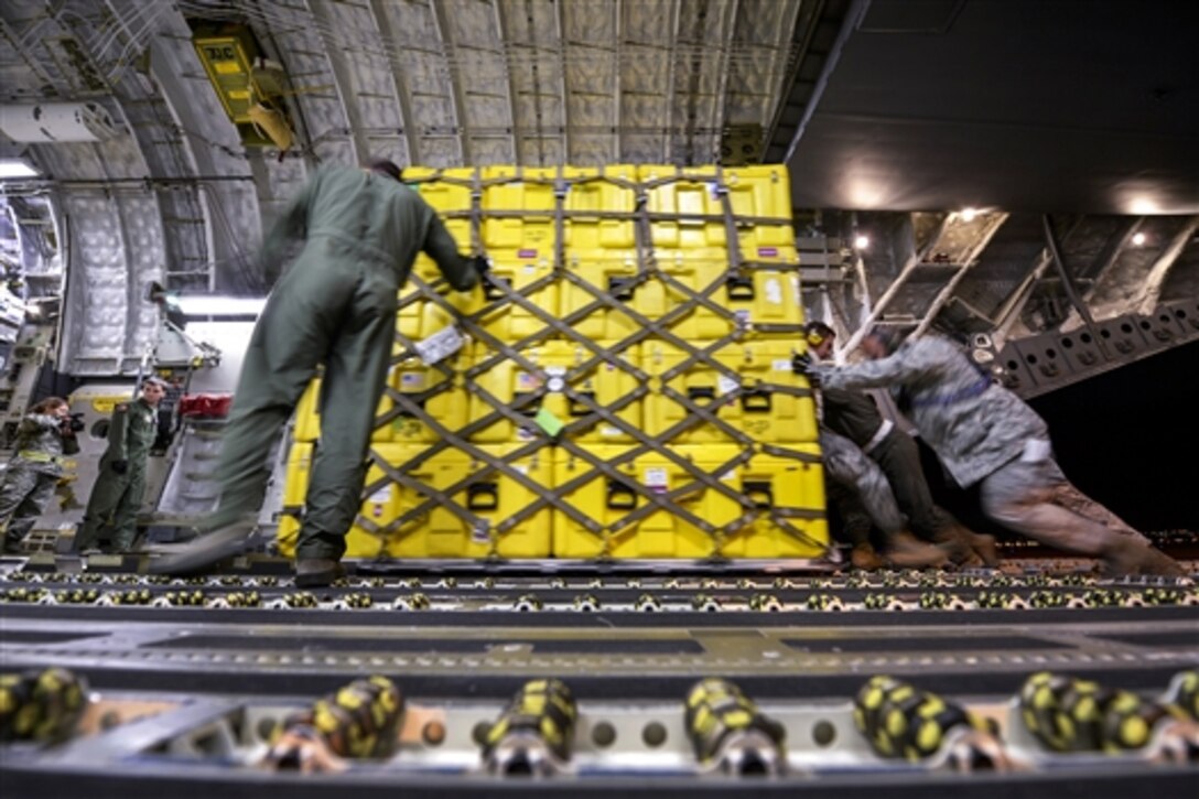 Airmen load pallets of equipment and supplies for victims of the Nepal earthquake into a U.S. Air Force C-17 Globemaster III aircraft on March Air Force Base, Calif., April 26, 2015.