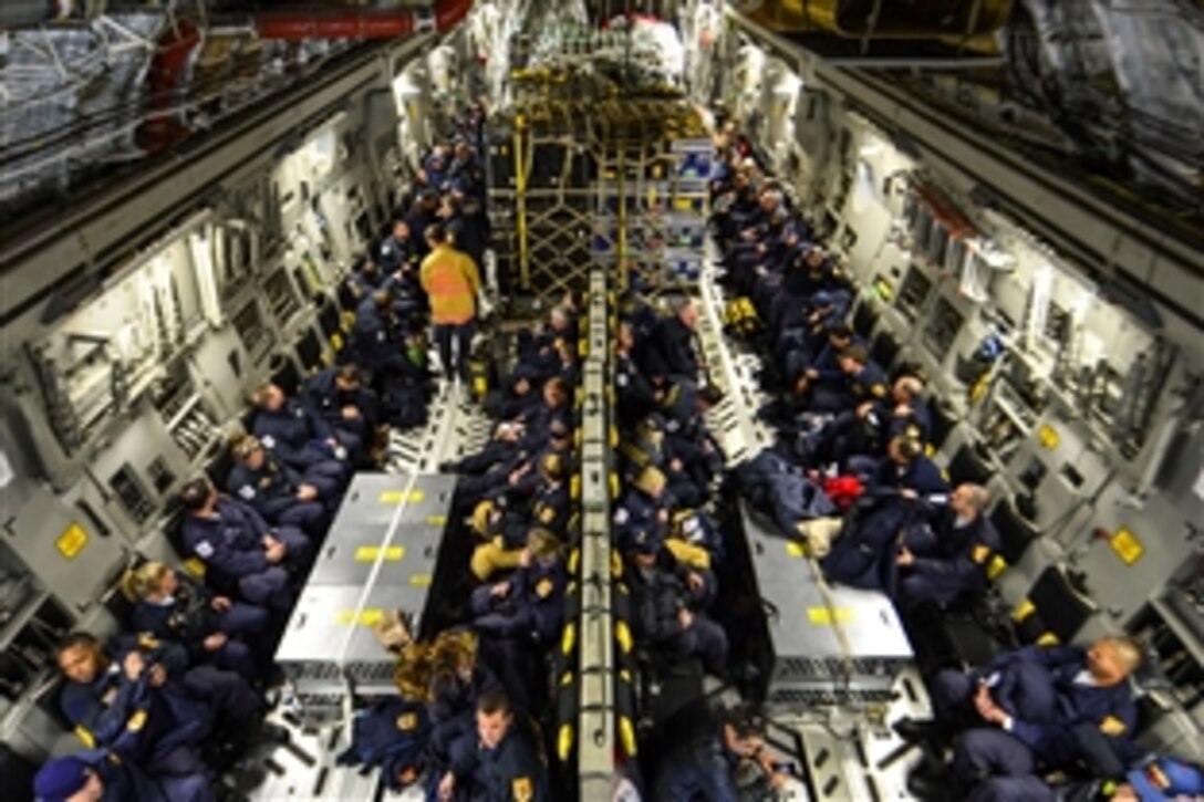 Sixty-nine members of the Fairfax County Urban Search and Rescue Team await takeoff on a U.S. Air Force C-17 Globemaster III from Dover Air Force Base, Del., April 26, 2015. The team and about 70,000 pounds of supplies are deploying to Nepal to assist with rescue operations after the country was struck by a 7.8-magnitude earthquake.