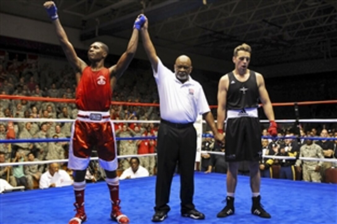 U.S. Air Force Senior Airman Antonio Lovette, left, raises his arms in victory after winning a preliminary fight against British Army Pvt. Matthew Sheridan at the International Paratrooper Brawl on Fort Bragg, N.C., April 23, 2015. Lovette is assigned to Minot Air Force Base, N.D.