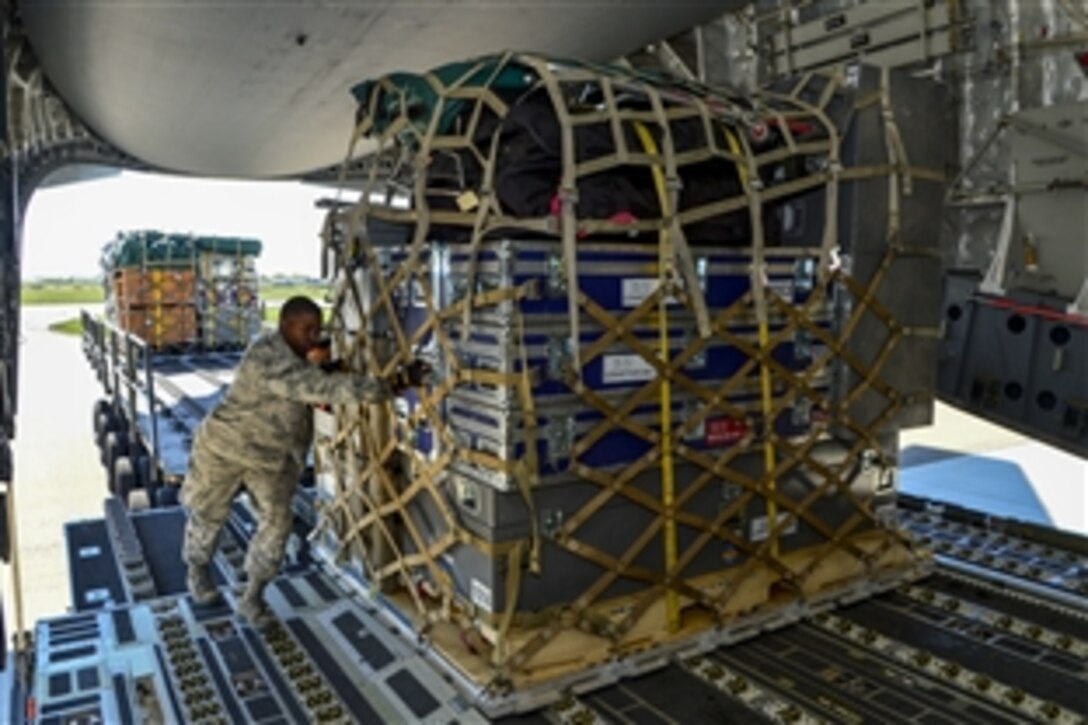 Air Force Senior Airman Tavin Alford loads equipment and supplies for the Fairfax County Urban Search and Rescue Team onto a C-17 Globemaster III on Dover Air Force Base, Del., April 26, 2015. The 69-member search and rescue team is deploying to Nepal to assist with rescue operations after the country was struck by a magnitude-7.8 earthquake. Alford is an air transportation journeyman assigned to the 436th Aerial Port Squadron. 