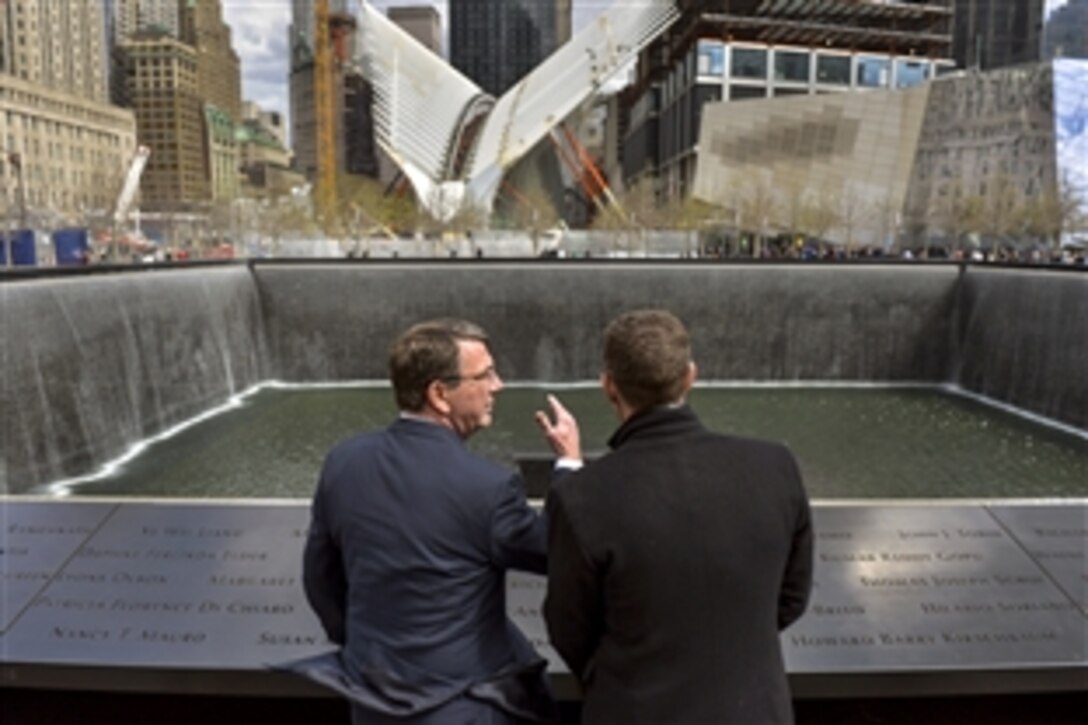 Defense Secretary Ash Carter, left, talks with 9/11 Memorial President Joe Daniels as they look over the memorial at ground zero in New York City, April 27, 2015. Carter traveled to the city to discuss new guidelines for U.S.-Japan defense cooperation with Japanese leaders and attend other events. 