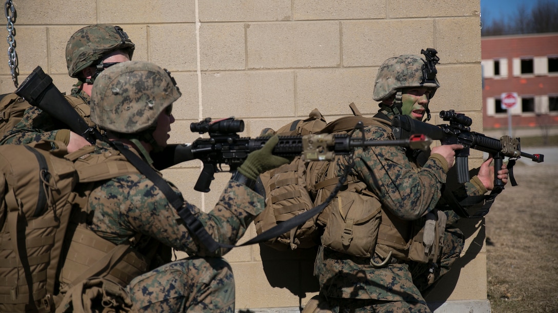 Marines with Charlie Company, 1st Battalion, 24th Marine Regiment, position themselves to clear a building with suspected enemy insurgents at Exercise Arctic Eagle, at Camp Grayling, Michigan, April 25, 2015. The Marines, with an attachment of soldiers from the Danish Home Guard, simulated retaking a city from enemy insurgents at Camp Grayling's Combined Armed Collective Training Facility.