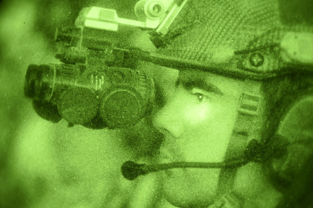 A U.S. Air Force combat controller, 21st Special Tactics Squadron, observes an AC-130 Gunship conduct a live-fire mission during Emerald Warrior at Camp Shelby, Miss., April 22, 2015. Emerald Warrior 2015 is the Department of Defense's only irregular warfare exercise, allowing joint and combined partners to train together and prepare for real world contingency operations. (U.S. Air Force photo by Staff Sgt. Jonathan Snyder/Released)
