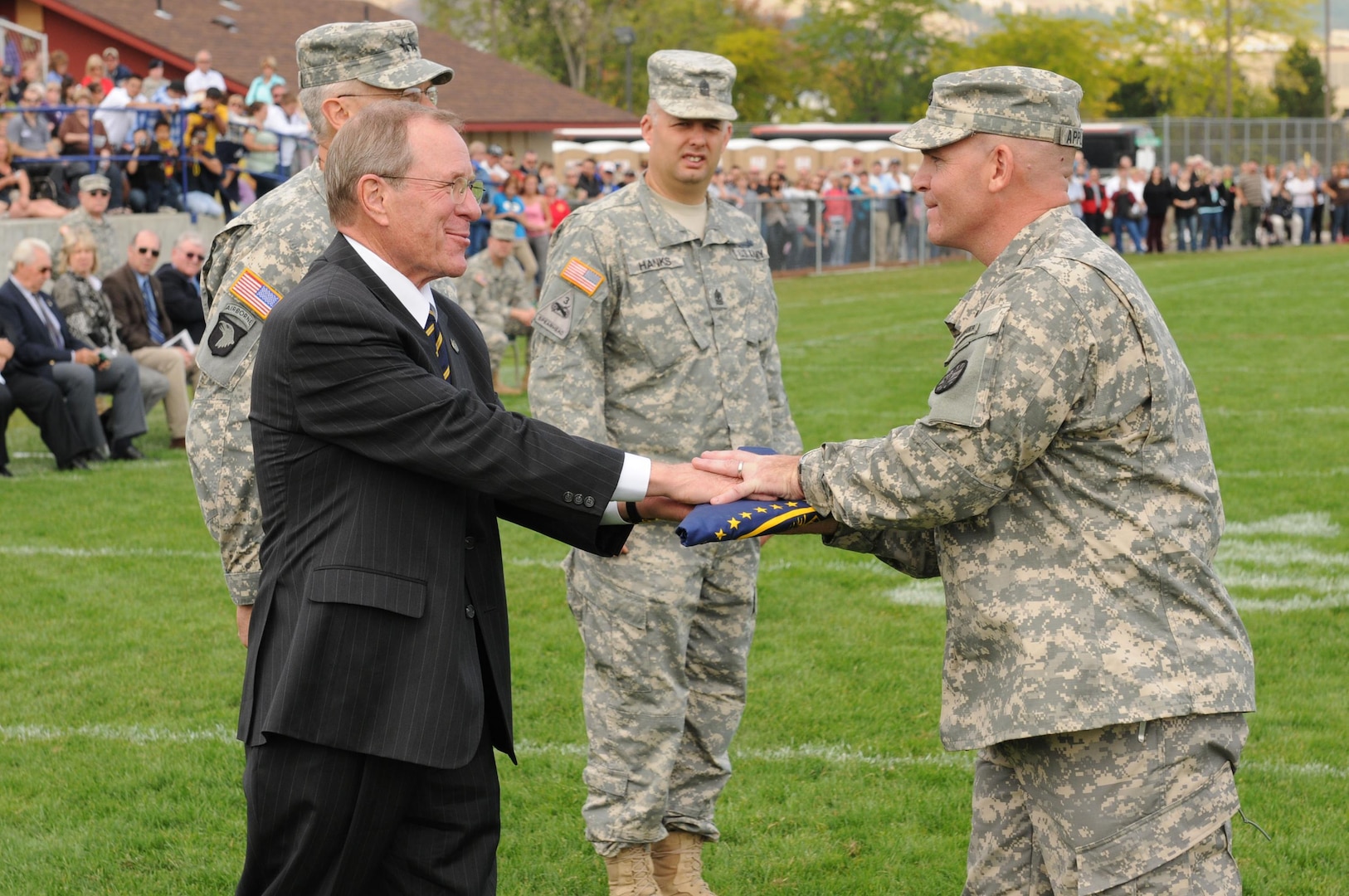 Oregon Gov. Theodore Kulongoski presents Oregon Army National Guard Lt. Col. Phillip Appleton with the Oregon State flag during the mobilization ceremony for the Oregon National Guard’s 3rd Battalion, 116th Cavalry, part of the 116th Cavalry Brigade Combat Team at Eastern Oregon University in LaGrande, Ore., Sept. 21, 2010. It is customary for Oregon units to fly the state flag above their Forward Operating Base in their deployed location, and as a tradition, Kulongoski presents the state flag to the unit commander at their mobilization ceremony.  More than 600 Oregon Guard Members will join Soldiers from Idaho and Montana for a one-year deployment to Iraq in support of Operation New Dawn.