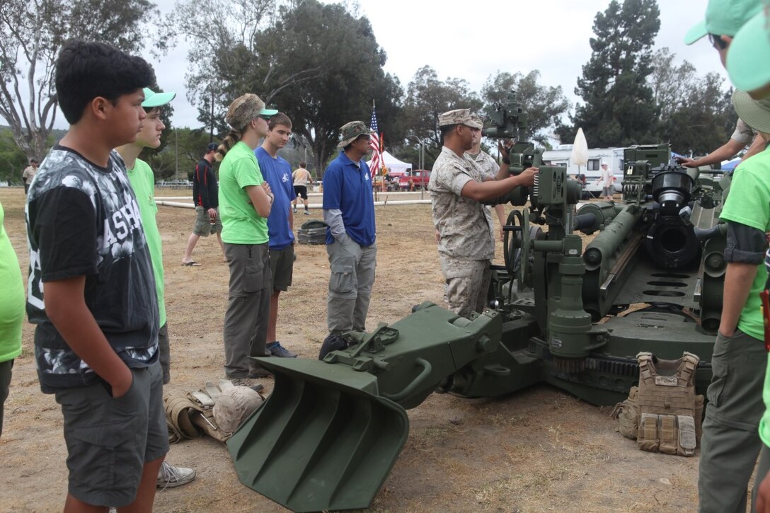 Sergeant Joshua L. Donald, section chief for Battery G, 2nd Battalion, 11th Marines, shows off a howitzer to local Boy Scouts aboard Camp Pendleton, Calif., April 25, 2015. Donald and other Marines displayed the  weaponry and its capabilities for the 2015 Spring Camporee.