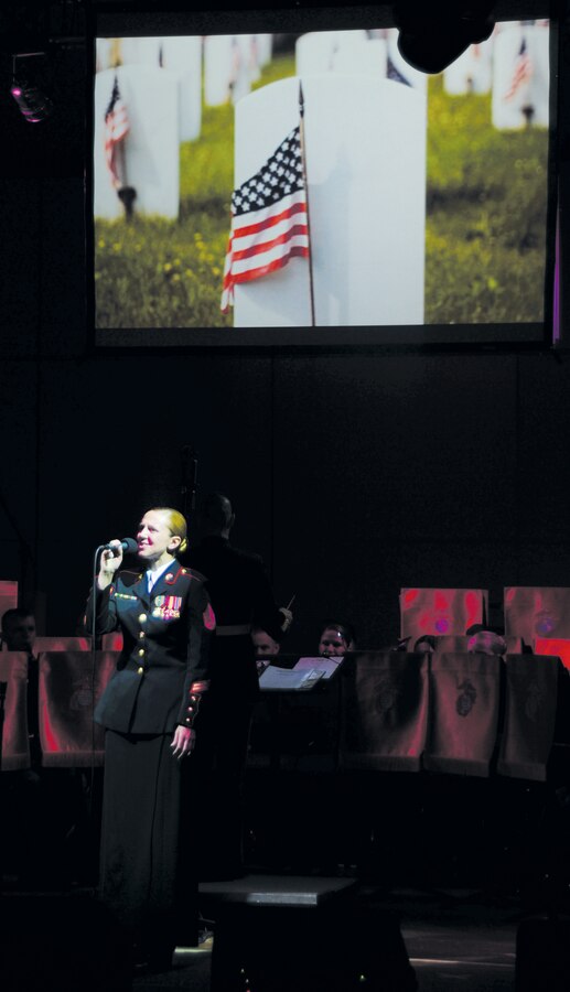 Staff Sgt. Terri Kopetzki, clarinetist and public affairs representative, Albany Marine Band, sings "There She Stands," during the Albany Marine Band's final concert at the Albany Municipal Auditorium in Albany, Ga., Feb. 14, 2012. Marine Corps Logistics Command officials honored the former Albany Marine Band with a display showcase and small ceremony, April 28, 2015, in Logistics Command’s Headquarters Building, aboard Marine Corps Logistics Base Albany.  