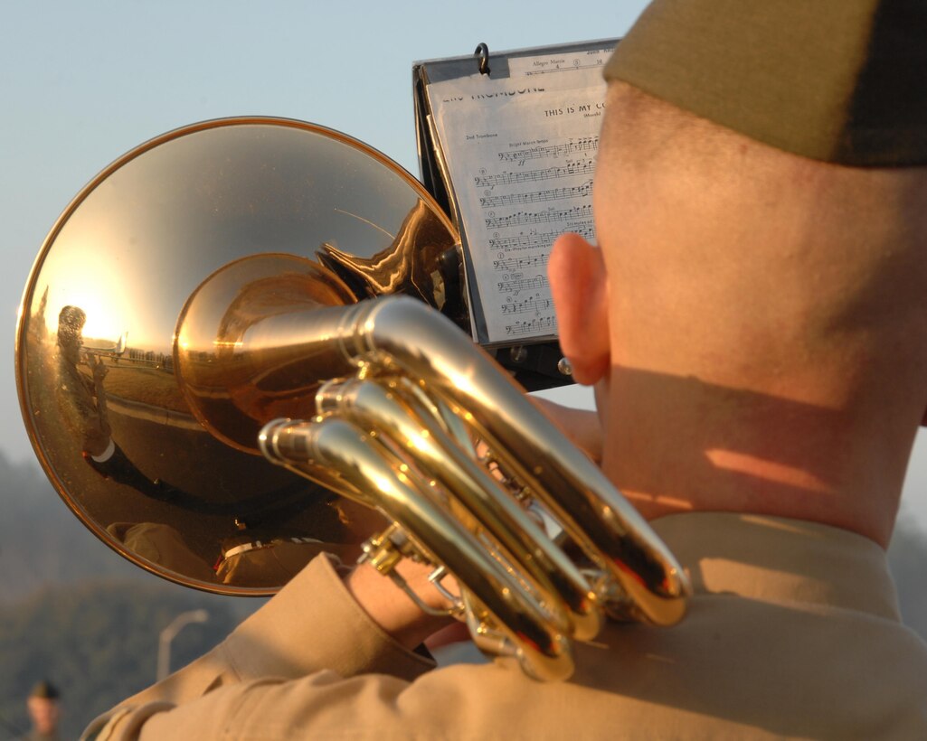 A Marine from the Albany Marine Band plays his musical instrument during a morning colors ceremony held in front of Marine Corps Logistics Base Albany's headquarters,  Feb. 18, 2011. Marine Corps Logistics Command officials honored the former Albany Marine Band with a display showcase and small ceremony April 28, 2015, in Logistics Command’s Headquarters Building, here.  