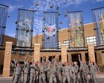 About 35 former high school dropouts toss their patrol caps in the air after receiving their high school diplomas at the National Guard Patriot Academy graduation held in Butlerville, Ind., Sept. 23, 2010.