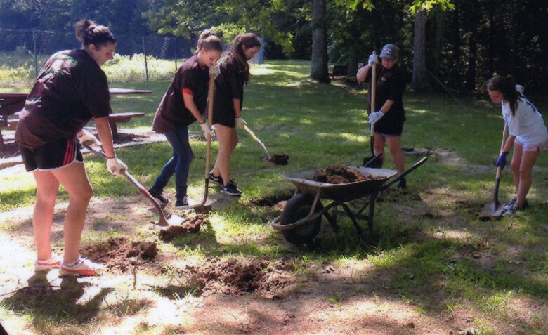 Girl Scout Rachel Cronin (far right) and her team prepare the ground at West Hill Dam for her Teeter-Totter Project that would earn her the Gold Award.