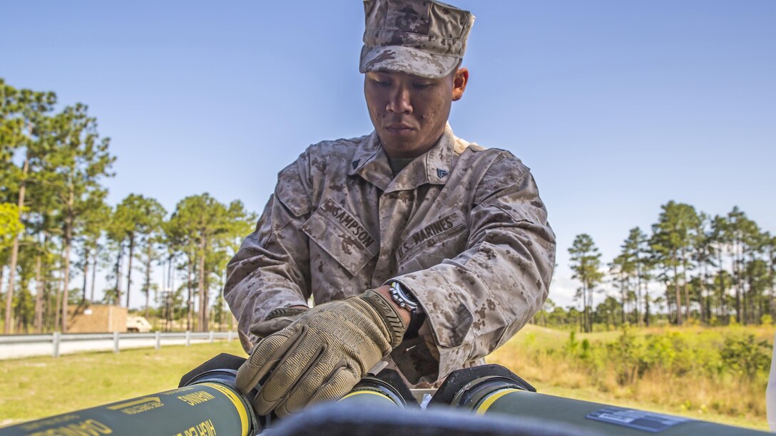 Corporal Christian Sampson, a squad leader with 2nd Combat Engineer Battalion, 2nd Marine Division, and Salina, Kan., native, handles a high explosive, dual purpose rocket before firing the shoulder-launched multipurpose assault weapon during live-fire training aboard Camp Lejeune, N.C., April 23, 2015. The Marines also trained with the M203 40mm grenade launcher, a single shot, under-barrel grenade launcher that is attached to an M16-A4 service rifle. 