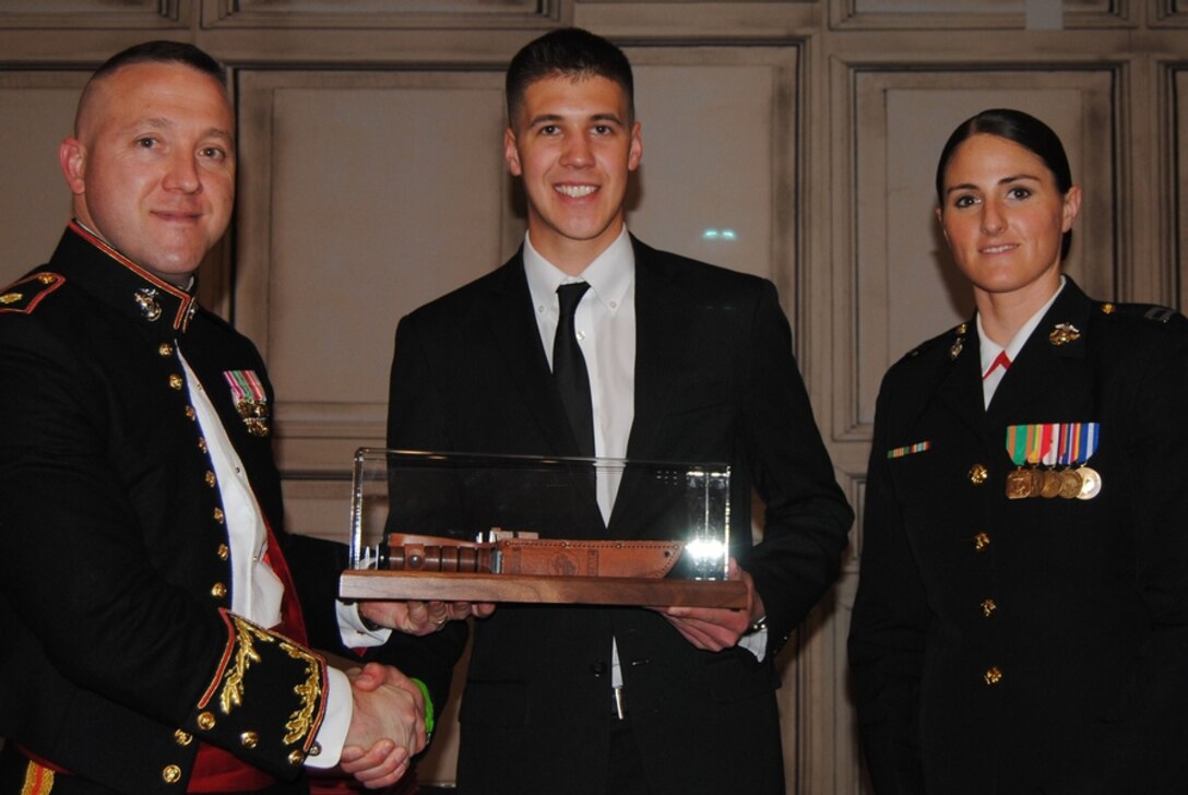 U.S. Marine Corps Maj. Donald L. Hotchkiss,left, Recruiting Station Louisville Commanding Officer, presents the  Col.  William R. Higgins Leadership Award to Miami University student, Ryan M. Muzzarelli at a mess night at the Campbel House Hotel in Lexington, Kentucky, March 28, 2015, for his outstanding leadership within the Platoon Leader Class. Muzzarelli is a senior at Miami University, Oxford, Ohio. He is studying Public Administration, and upon graduation he will accept a commission into the United States Marie Corps as a second lieutenant. (Courtesy photo by Marine Corps Coordinating Council Kentucky) 