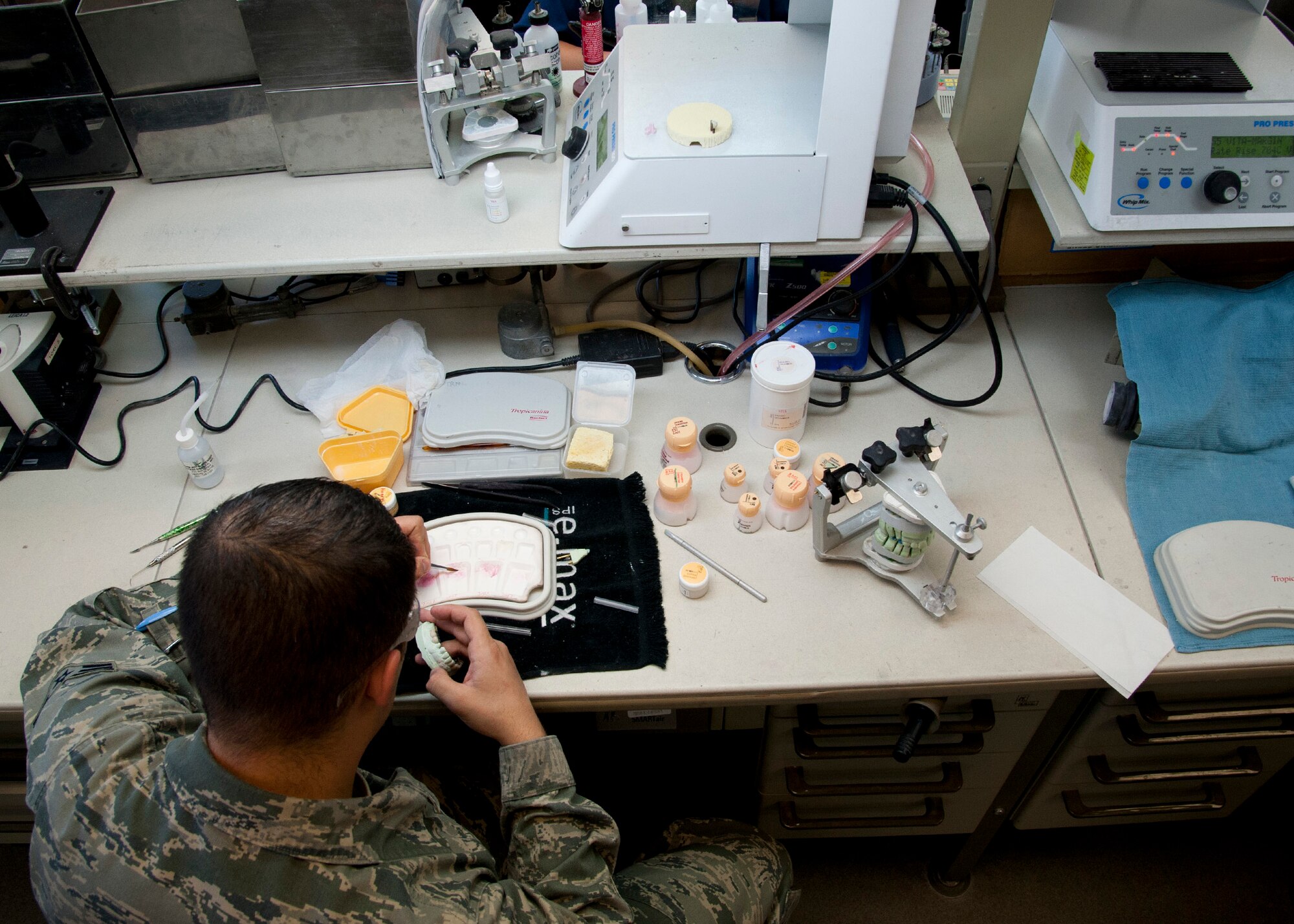 Senior Airman Jonathon Stambaugh, a 21st Dental Squadron dental lab technician, works on creating porcelain teeth at the Area Dental Lab April 8, 2015, on Peterson Air Force Base, Colo. The ADL is one of three Defense Department labs that provide fixed dental works along with removable dental works and services DOD bases around the world. (U.S. Air Force photo/Senior Airman Tiffany DeNault)
