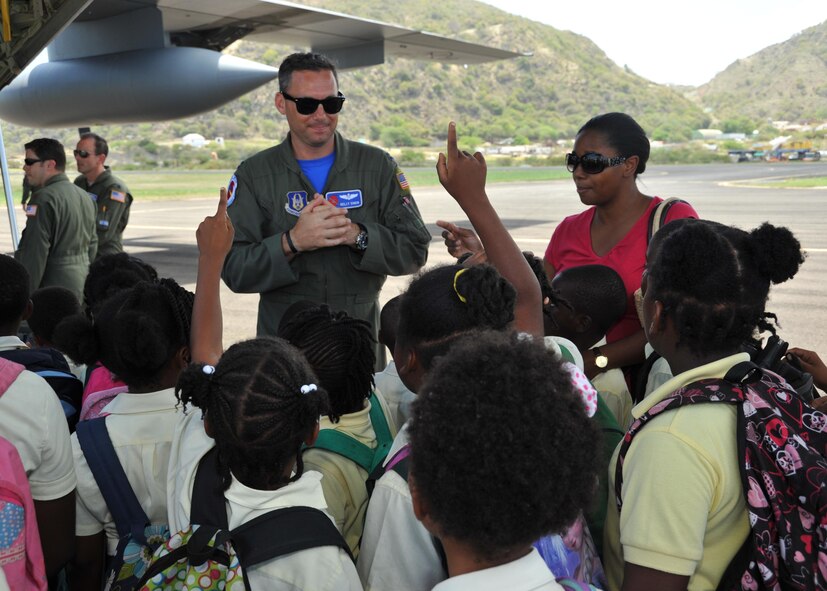 Capt. Kelly Soich, 53rd Weather Reconnaissance Squadron navigator, answers grade school students’ questions during the Caribbean Hurricane Awareness Tour April 24, 2015. More than 500 students were informed how the Hurricane Hunters use the WC-130J to collect vital weather data for the National Hurricane Center in Miami, which improves their forecasts. About 50 students from Saba made an hour ferry ride to attend the event designed to promote hurricane awareness and preparedness in the Caribbean region April 20-25. The outreach program began in the 1970's and is a joint effort between National Oceanic and Atmospheric Administration's National Hurricane Center and the 403rd Wing's 53rd Weather Reconnaissance Squadron. (U.S. Air Force photo/Maj. Marnee A.C. Losurdo)
