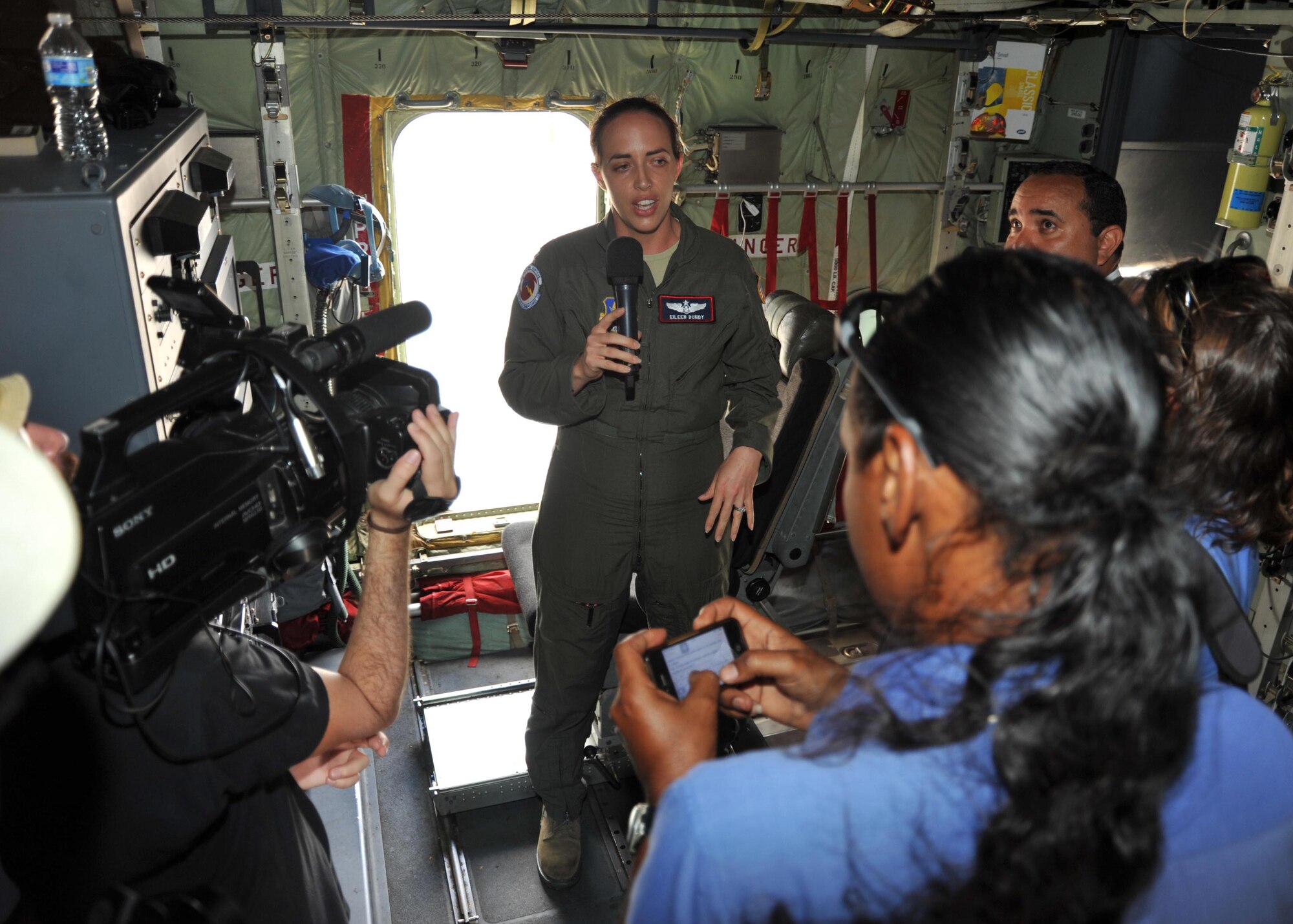Maj. Eileen Bundy, 53rd Weather Reconnaissance Squadron aerial reconnaissance weather officer, answers the media’s questions during a tour of the WC-130J at the Flamingo Airport, Bonaire, April 22, 2015, during the Caribbean Hurricane Awareness Tour. More than 1,500 community leaders, students and locals toured the WC-130J, which was on display as part of the CHAT. The outreach program, which began in the 1970's and is a joint effort between National Oceanic and Atmospheric Administration's National Hurricane Center and the 403rd Wing's 53rd Weather Reconnaissance Squadron, promotes hurricane awareness and preparedness throughout the Caribbean region. (U.S. Air Force photo/Maj. Marnee A.C. Losurdo)
