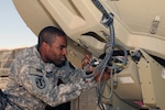 Chief Warrant Officer 2 Clinton Store, network operations and satellite terminal technician for the 196th Maneuver Enhancement Brigade of the South Dakota Army National Guard does a routine check on a satellite network terminal at Camp Phoenix in Kabul, Afghanistan, Sept. 22, 2010. The satellite allows for secure network access in almost any remote field location to provide internet and telephone services to field units where normal ground communication lines are not available.