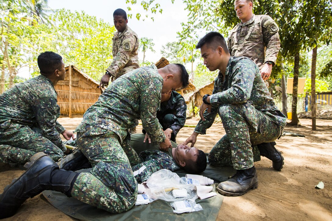 Philippine Marine Corps Cpl. Jose Ryan Tinio, a combat medic with Battalion Landing Team 4, 3rd Marine Brigade, acts as a simulated casualty while participants of the Tactical Combat Casualty training apply medical care in Puerto Princesa, Philippines, during exercise Balikatan 2015, April 27. The Tactical Combat Casualty Care training, taught by U.S. armed forces, was held to practice techniques to respond to crisis in the region effectively.