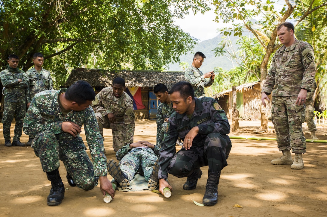 U.S. Army Staff Sgt. David Howell, a combat medic with Delta Company, 97th Civil Affairs Battalion, Civil Affairs Team 742, evaluates members from the Philippine Marines, Coast Guard, and National Police during Tactical Combat Casualty training in Puerto Princesa, Philippines, during exercise Balikatan 2015, April 27. The Tactical Combat Casualty Care training, taught by U.S. armed forces, was held to practice techniques to respond to crisis in the region effectively.