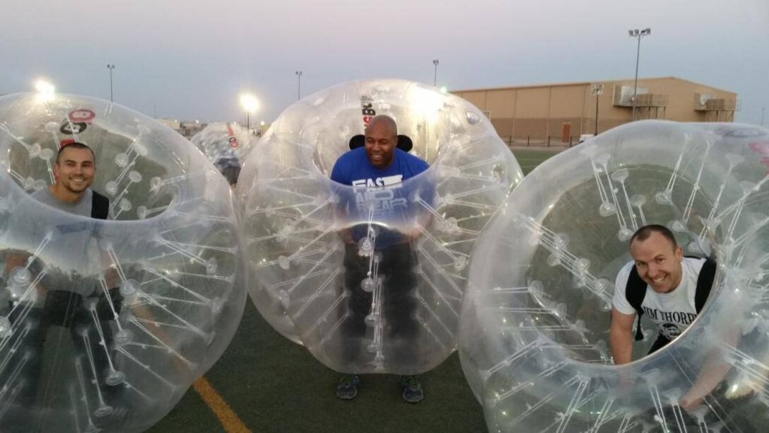 Three members of the 542nd Forward Engineering Support Team - Advanced compete in a base-sponsored BubbleBall soccer tournament. BubbleBall is the latest sports craze that encases players in the center of an over-sized polyvinyl bubble ball during play. Between missions, FEST-A members recreate during team-building activities or connect with family and friends in the states via FaceTime, Skype and other forms of electronic communication.