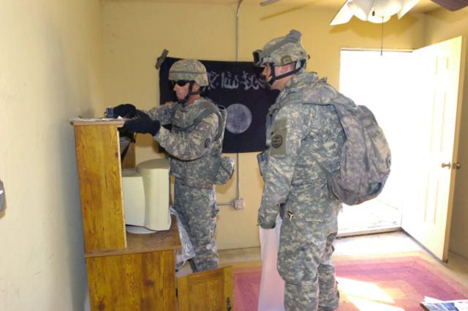 Idaho National Guard members from the 116th Cavalry Brigade Combat Team's Company Intelligence Support Teams collect intelligence materials during a recent exercise at the tactical search house on Camp Shelby Joint Forces Training Center in Camp Shelby, Miss.