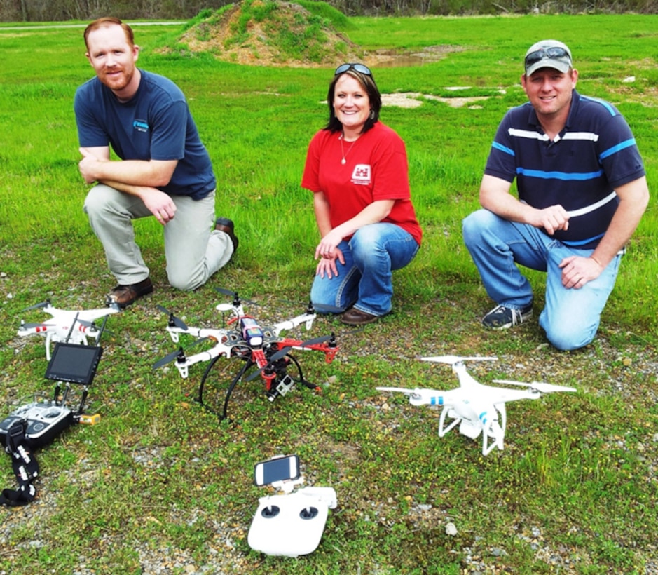 EL’s team from the Environmental Risk Assessment Branch for unmanned aircraft systems  (EPR-UAS) showing their remotely controlled  flying machines are, from left, Justin Wilkens with the Phantom 2 Vision; Jenny Laird with the Flamewheel F550; and Robbie Boyd with the second Phantom 2. Project managers can contact team members to schedule a demonstration of the UASs and learn about monitoring or sampling of dangerous or environmentally sensitive sites. EL photo.