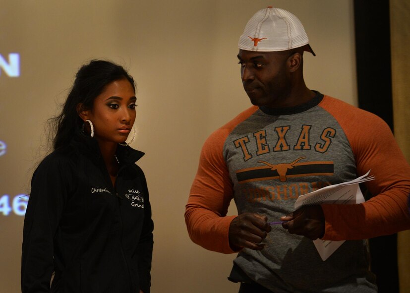 U.S. Air Force Senior Airman Christine Siquig, 27th Special Operations Force Support Squadron personal readiness technician, receives last-minute guidance from Master Sgt. Marvin Jimerson, 27th Special Operations Maintenance Squadron first sergeant, at the Cannon Classic April 25, 2015 at Cannon Air Force Base, N.M. This was Siquig’s first natural body building competition and her hard work garnered a third place finish. (U.S. Air Force photo/Airman 1st Class Chip Slack)