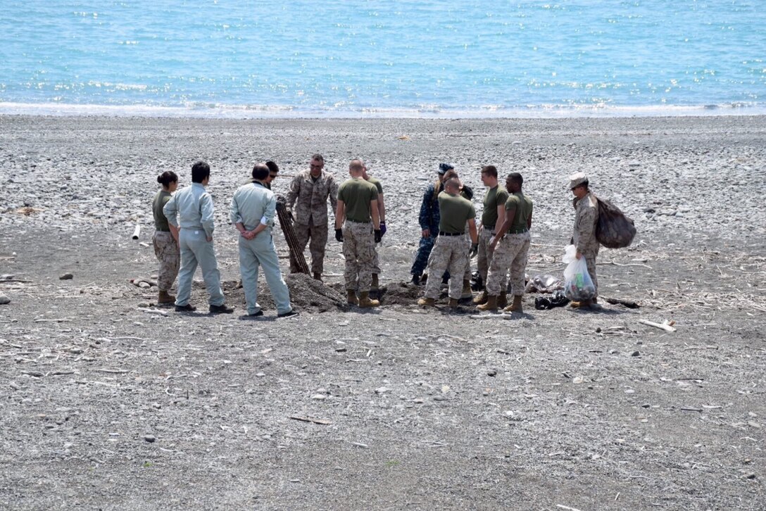 Marines, sailors, and civilians from CATC Camp Fuji conducted a clean-up of the Marine Corps training area at Numazu Beach in commemoration of Earth Day, Thursday April 23, 2015.