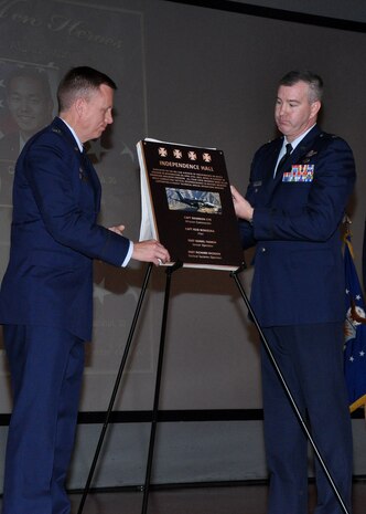Col. Douglas Lee, 9th Reconnaissance Wing commander and Lt. Col. James Mansard, 69th Reconnaissance Group deputy commander unveil a graphical representation of the plaque that will be permanently mounted at the entrance to the newly dedicated Independence Hall at Beale Air Force Base, Calif., April 27, 2015. (U.S. Air Force photo by Airman 1st Class Taylor A. Workman/Released)