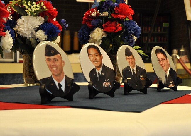 Pictures of the fallen Airmen of Independence 08 positioned at the entrance to the newly dedicated Independence Hall at Beale Air Force Base, Calif., April 27, 2015. The event marked the two year anniversary of their sacrifice when their MC-12 Liberty crashed during a combat operation in Afghanistan. (U.S. Air Force photo by Airman 1st Class Taylor A. Workman/Released)