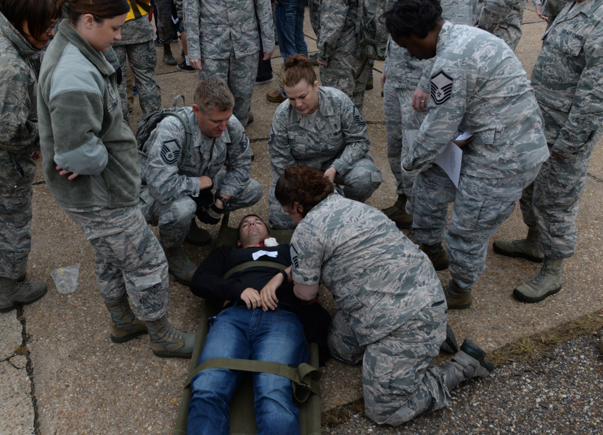 A medical response team treats an Airman with simulated injuries during a Major Accident Response Exercise on Barksdale Air Force Base, Louisiana, April 28, 2015. Airmen from the 2nd Medical Group were evaluated on how promptly and effectively they responded to the simulated injuries and casualties during the incident. (U.S. Air Force photo/Airman 1st Class Curt Beach)