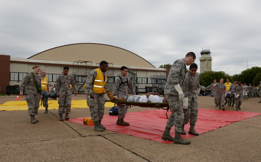 Barksdale Airmen litter-carry a simulated casualty during a Major Accident Response Exercise on Barksdale Air Force Base, Louisiana, April 28, 2015. The 2nd Bomb Wing holds an annual MARE before every air show to evaluate how base units and community emergency services agencies would respond to an incident. (U.S. Air Force photo/Airman 1st Class Curt Beach)