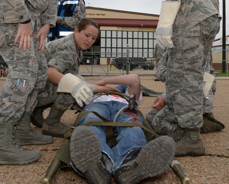 Barksdale Airmen respond to a simulated victim during a Major Accident Response Exercise on Barksdale Air Force Base, Louisiana, April 28, 2015. More than 50 people volunteered to act as similuted victims and casualties for the exercise, assisting wing inspection team members in evaluating how medical, security forces and several base and community emergency services agencies responded to the incident. (U.S. Air Force photo/Airman 1st Class Curt Beach)