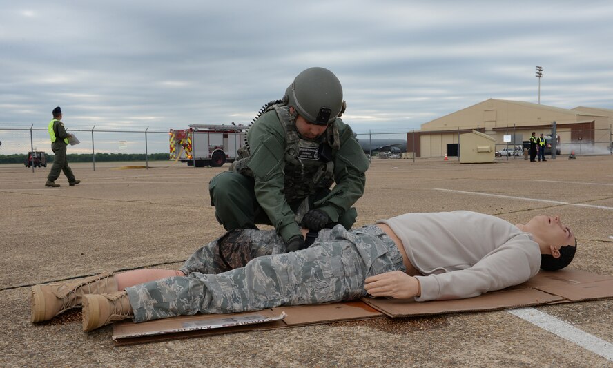 A Barksdale defender applies a tourniquet to a simulated victim during a Major Accident Response Exercise on Barksdale Air Force Base, Louisiana, April 28, 2015. The exercise was held in preparation for any emergencies that may be encountered during an air show, evaluating several base and community emergency services and their level of response. (U.S. Air Force photo/Airman 1st Class Curt Beach)