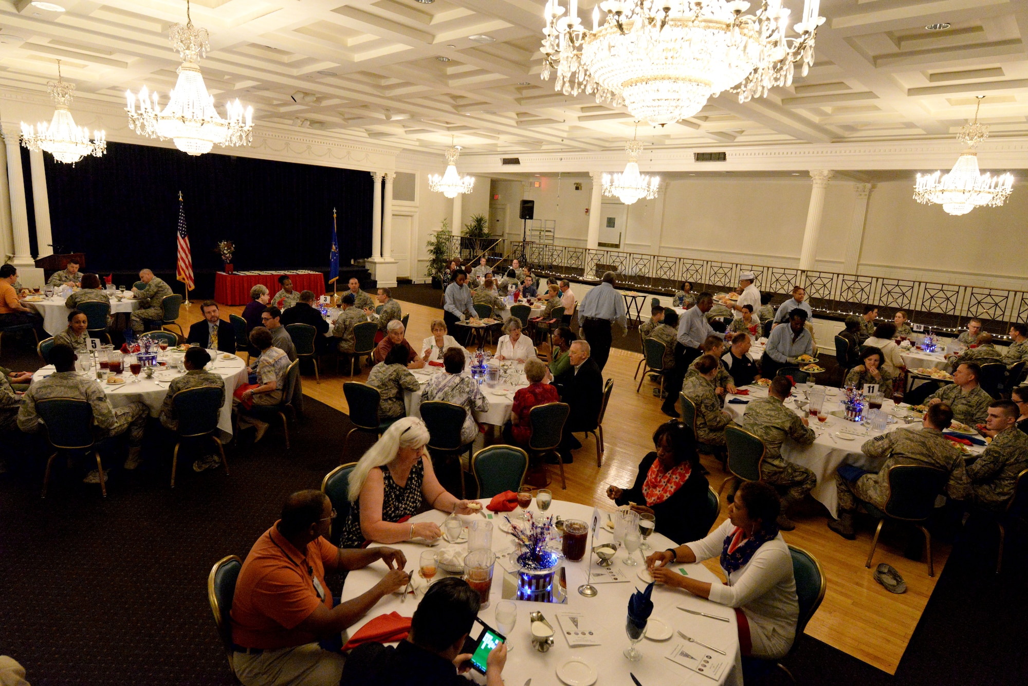 Attendees of the Volunteer Recognition Ceremony luncheon dine together before the presentation of awards, April 21, 2015, Maxwell Air Force Base, Alabama. The ceremony recognized the volunteer service of retirees, active duty military, Department of Defense employees and family members. (U.S. Air Force photo by Airman 1st Class Alexa Culbert/Cleared)