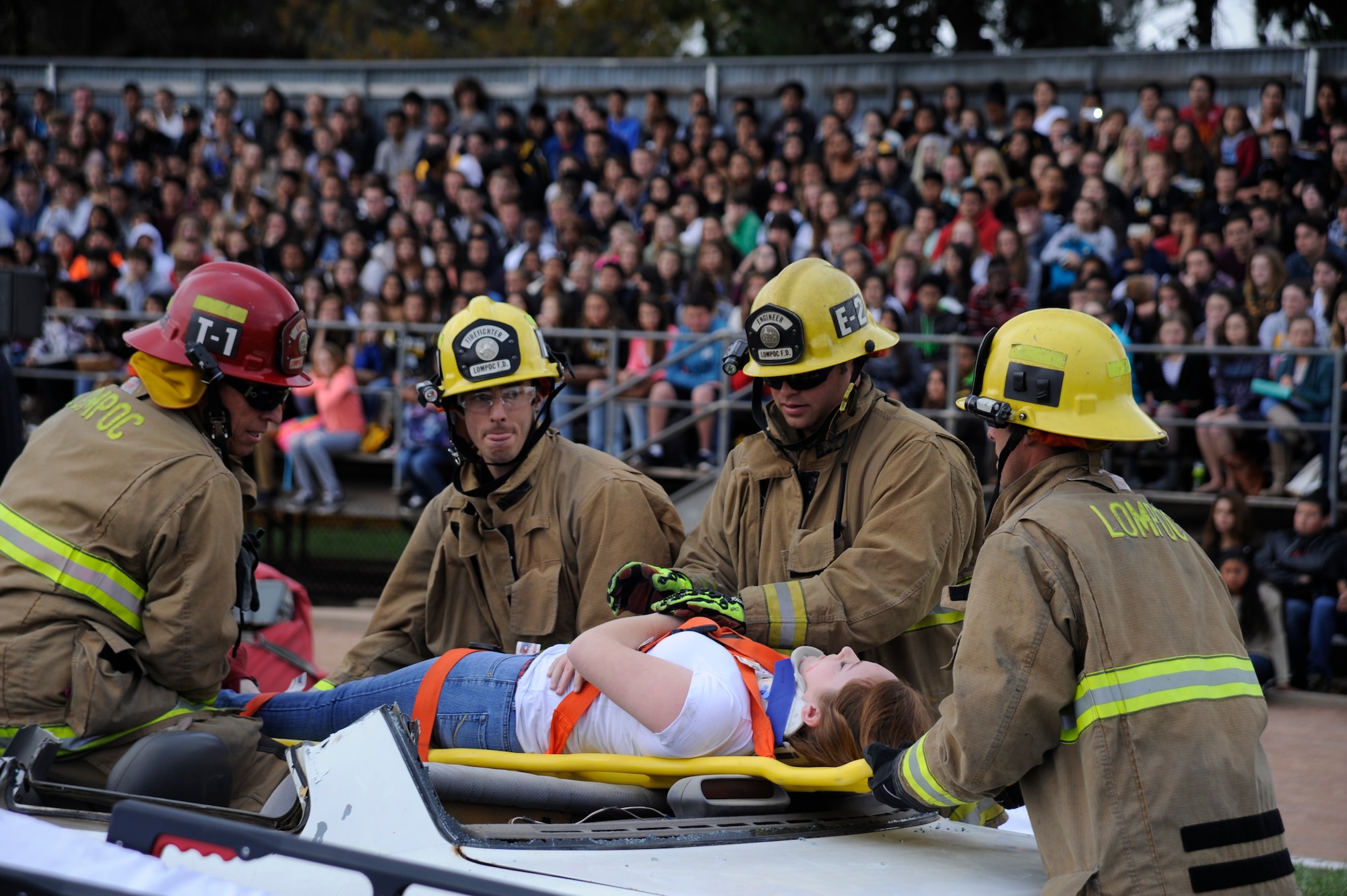 Firefighters extricate a student from a wrecked vehicle April 21, 2015, Cabrillo High School, Calif. This demonstration was part of an annual program called "Every 15 Minutes", which shows the negative consequences of drinking and driving. (U.S. Air Force photo by Airman 1st Class Ian Dudley/Released)