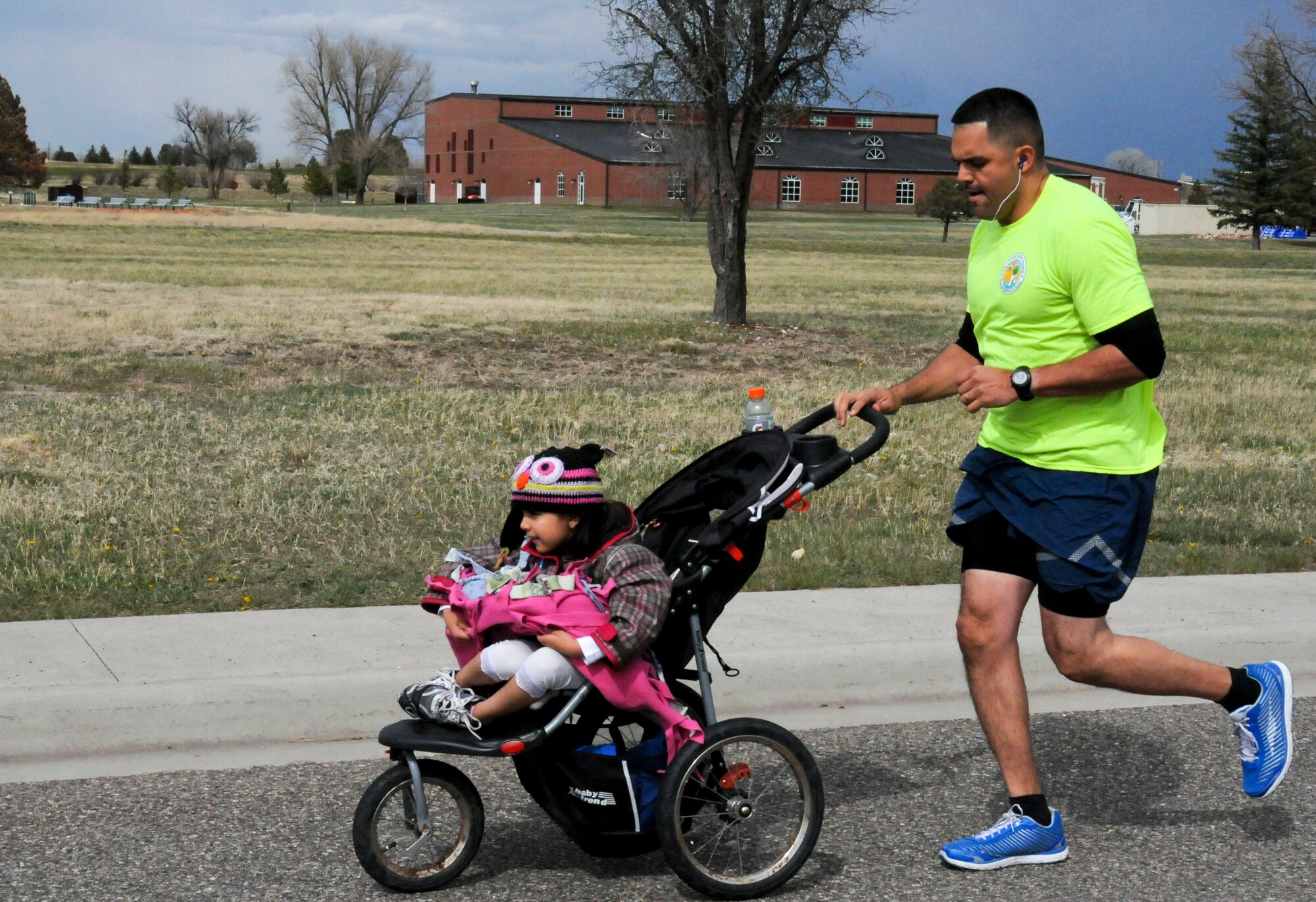 Roberto Rodriguez-Santiago, 90th Contracting superintendent, and his daughter Ava, 5, participate in the Sexual Assault Prevention and Response Awareness 5k Run on F.E. Warren Air Force Base, Wyo. April 24, 2015. Around 40 participants from various units across Warren compete and showed their support for the event. (U.S. Air Force photo by Airman 1st Class Malcolm Mayfield)