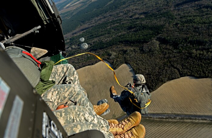 U.S. Army Maj. Stewart Brown, 55th Signal Company, jumps from a UH-60 Black Hawk, 1st Battalion, 171st Aviation Regiment, during airborne operations at Plantation Airpark, Sylvania, Ga. March 20, 2015. Operation Skyfall is a joint, multi-lateral combat camera subject matter expert exchange, hosted by the 982nd Combat Camera Company, which takes place at multiple locations in Georgia. Operation Skyfall is an event which focuses on interoperability of combat camera training and capturing airborne operations with three partner nations and multi-service units. (U.S. Air Force photo by Staff Sgt. Nathan Lipscomb/Released)