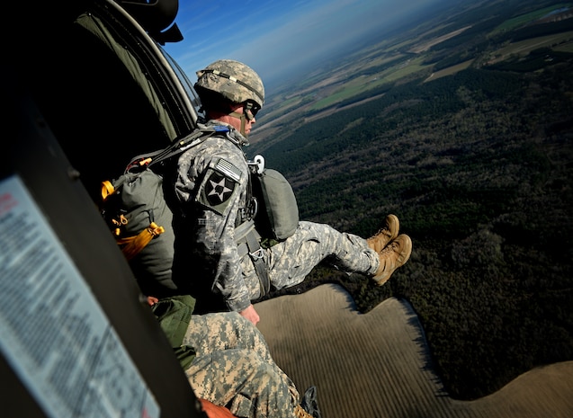 U.S. Army Maj. Stewart Brown, 55th Signal Company, jumps from a UH-60 Black Hawk, 1st Battalion, 171st Aviation Regiment during airborne operations at Plantation Airpark, Sylvania, Ga. March 20, 2015. Operation Skyfall is a joint, multi-lateral combat camera subject matter expert exchange, hosted by the 982nd Combat Camera Company, which takes place at multiple locations in Georgia. Operation Skyfall is an event which focuses on interoperability of combat camera training and capturing airborne operations with three partner nations and multi-service units. (U.S. Air Force photo by Staff Sgt. Nathan Lipscomb/Released)