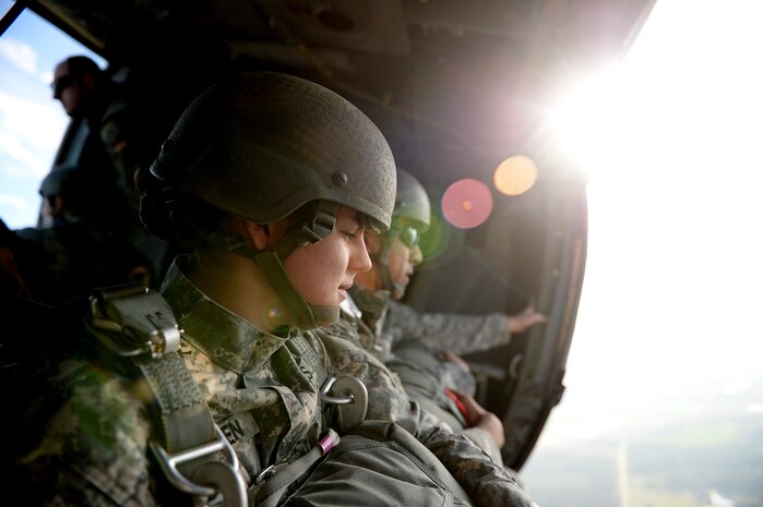 U.S. Army Spc. Nikayla Shodeen, 55th Signal Company Combat Camera prepares to jump from a UH-60 Black Hawk, 1st Battalion, 171st Aviation Regiment during airborne operations, at Plantation Airpark, Sylvania, Ga. March 20, 2015. Operation Skyfall is a joint, multi-lateral combat camera subject matter expert exchange, hosted by the 982nd Combat Camera Company, which takes place at multiple locations in Georgia. Operation Skyfall is an event which focuses on interoperability of combat camera training and capturing airborne operations with three partner nations and multi-service units. (U.S. Air Force photo by Staff Sgt. Nathan Lipscomb/Released)
