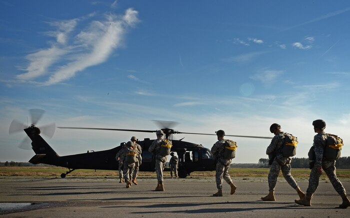 Operation Skyfall 2015 participants load a UH-60 Black Hawk, 1st Battalion, 171st Aviation Regiment at Plantation Airpark, Sylvania, Ga. March 20, 2015. Operation Skyfall is a joint, multi-lateral combat camera subject matter expert exchange, hosted by the 982nd Combat Camera Company, which takes place at multiple locations in Georgia. Operation Skyfall is an event which focuses on interoperability of combat camera training and capturing airborne operations with three partner nations and multi-service units. (U.S. Air Force photo by Staff Sgt. Nathan Lipscomb/Released)