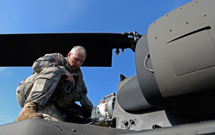 U.S. Army Sgt. Eddie Boyd, 1st Battalion, 171st Aviation Regiment, inspects a UH-60 Black Hawk after a refueling stop during airborne operations, at Sylvania, Ga. March 20, 2015. Operation Skyfall is a joint, multi-lateral combat camera subject matter expert exchange, hosted by the 982nd Combat Camera Company, which takes place at multiple locations in Georgia. Operation Skyfall is an event which focuses on interoperability of combat camera training and capturing airborne operations with three partner nations and multi-service units. (U.S. Air Force photo by Staff Sgt. Nathan Lipscomb/Not Released)