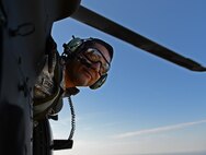 U.S. Army Staff Sgt. Juan Armenderiz, 528th Sustainment Brigade, U.S. Army Special Operations Command, checks the drop zone during airborne operations at Plantation Airpark, Sylvania, Ga. on March 20, 2015. Operation Skyfall is a joint, multi-lateral combat camera subject matter expert exchange, hosted by the 982nd Combat Camera Company, which takes place at multiple locations in Georgia. Operation Skyfall is an event which focuses on interoperability of combat camera training and capturing airborne operations with three partner nations and multi-service units. (U.S. Air Force photo by Staff Sgt. Nathan Lipscomb/Released)