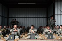 Operation Skyfall 2015 participants wait for their chance to parachute from a UH-60 Black Hawk, 1st Battalion, 171st Aviation Regiment at Plantation Airpark, Sylvania, Ga. March 20, 2015. Operation Skyfall is a joint, multi-lateral combat camera subject matter expert exchange, hosted by the 982nd Combat Camera Company, which takes place at multiple locations in Georgia. Operation Skyfall is an event which focuses on interoperability of combat camera training and capturing airborne operations with three partner nations and multi-service units. (U.S. Air Force photo by Staff Sgt. Nathan Lipscomb/Released)