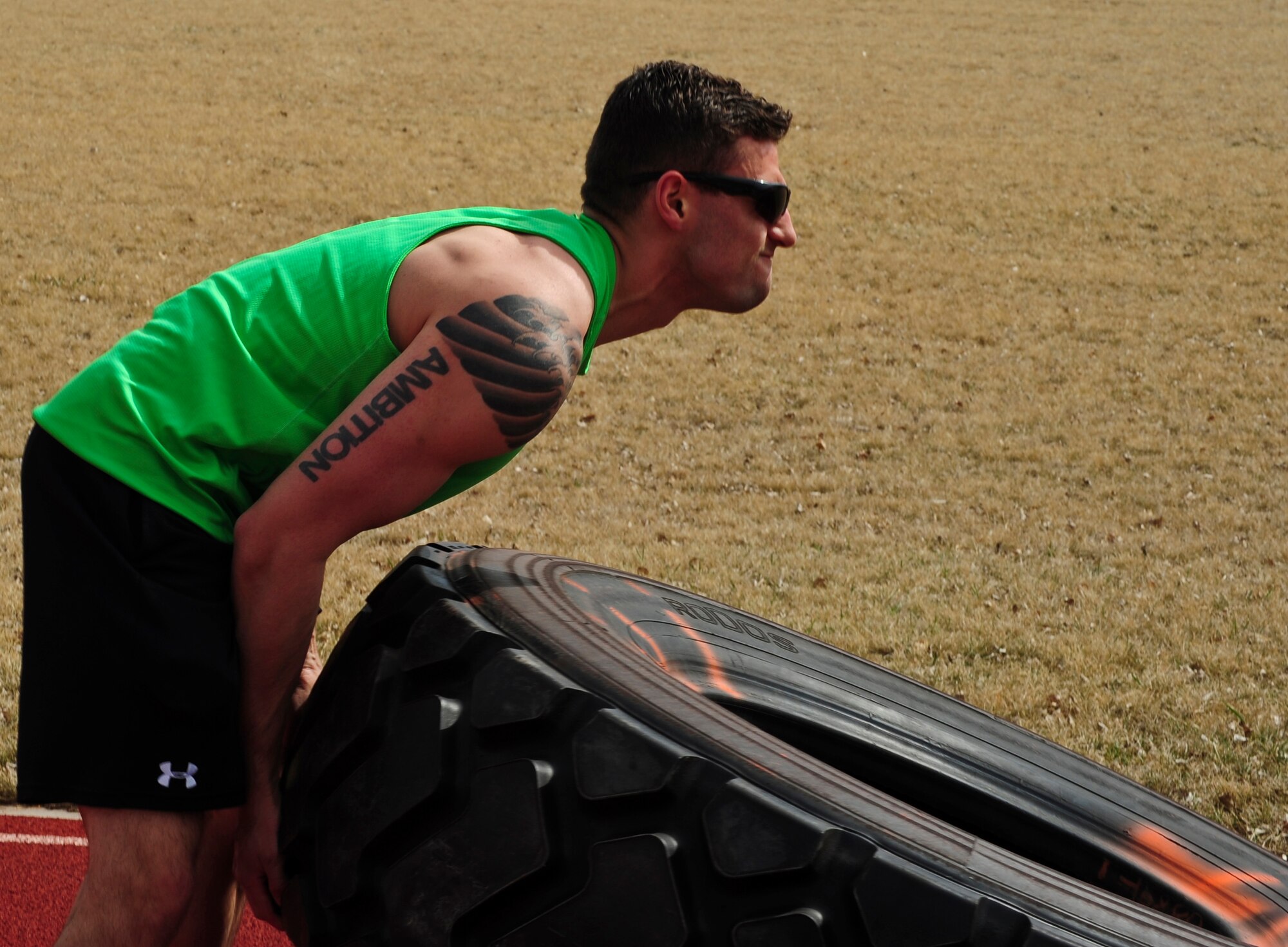 Senior Airman Joshua L. Coonich, 319th Medical Operations Squadron flight medicine medical technician, flips a tire April 18, 2015, on Grand Forks Air Force Base, N.D. Coonich, a Schaumburg, Ill. native, leads training sessions for a small group of Airmen attempting to transfer into a Battlefield Airman career field. (U.S. Air Force photo by Airman 1st Class Ryan Sparks/released)