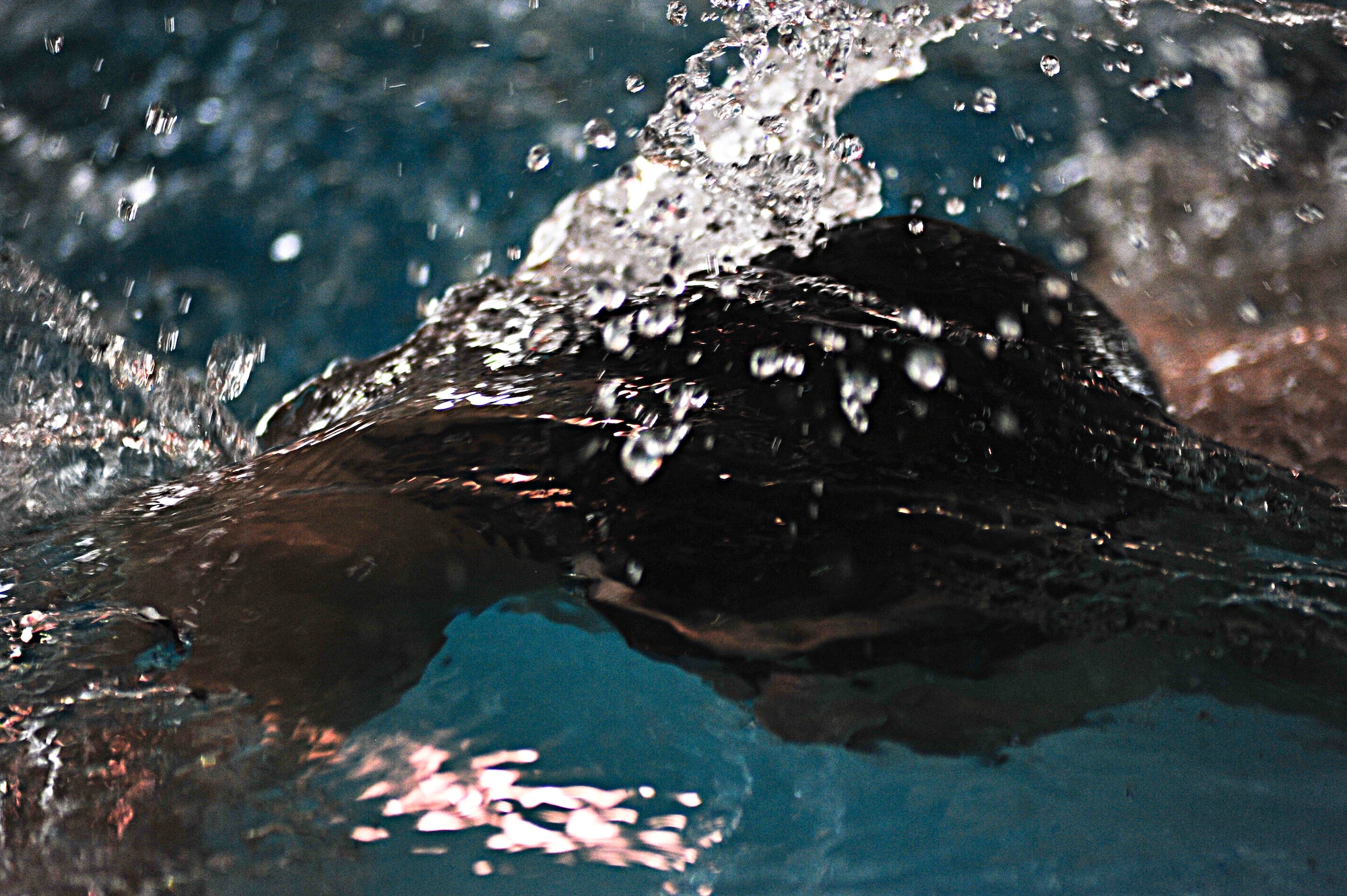 Senior Airman Joshua L. Coonich, 319th Medical Operations Squadron flight medicine medical technician, swims a lap at the Aquatic Center April 18, 2015, on Grand Forks Air Force Base, N.D. Coonich, a Schaumburg, Ill. native, is preparing for his pararescuman training. (U.S. Air Force photo by Airman 1st Class Ryan Sparks/released)