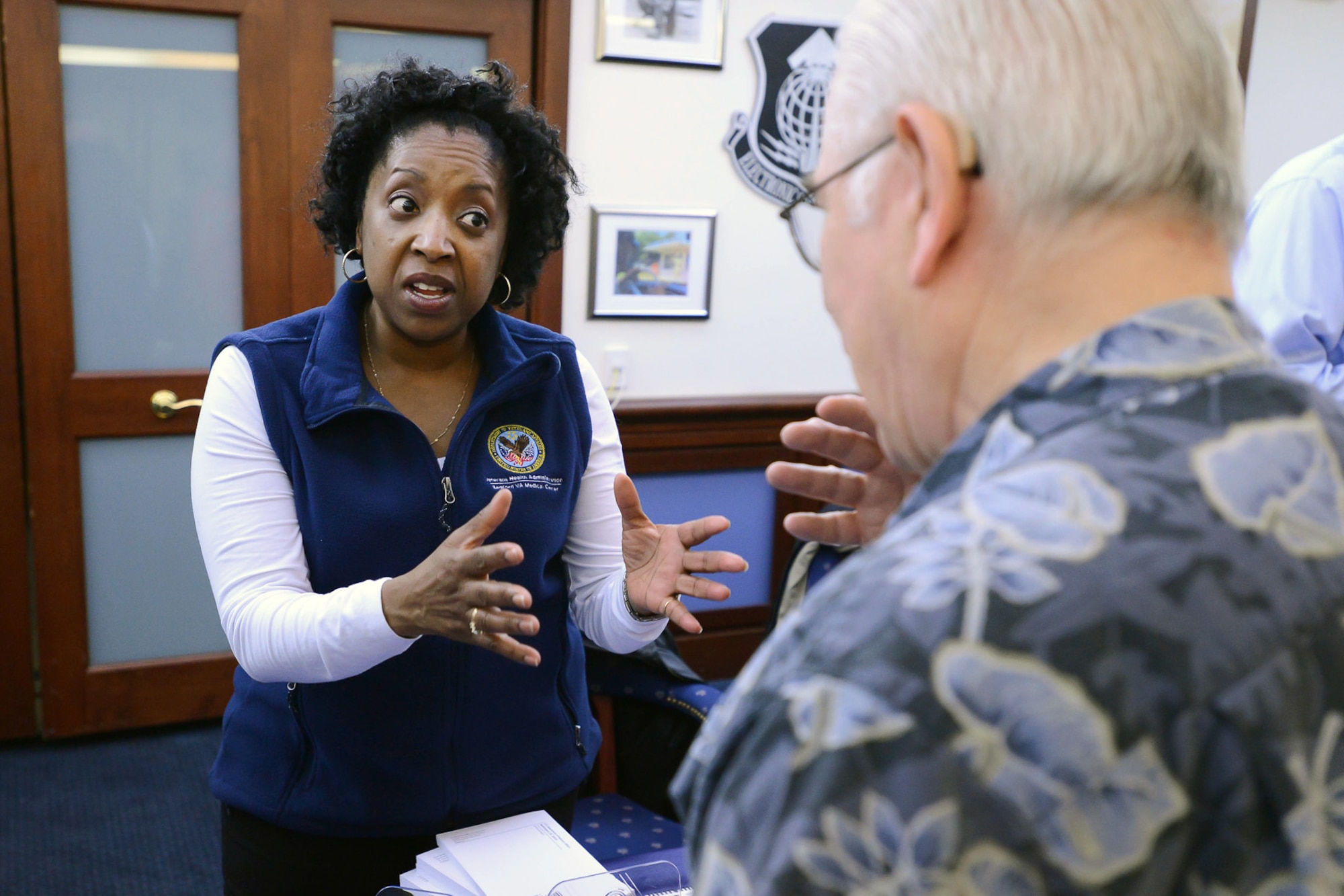 Jacque Holliday, Bedford Veterans Administration Medical Center outreach coordinator, speaks with retirees during the Military Retiree Day event at the Minuteman Commons, April 24. The event kicked off with an Information Services session that provided retirees an opportunity to browse 20 information tables staffed by representatives of both on- and off-base agencies and organizations. Col. Michael A. Vogel, installation commander, was the keynote speaker during a luncheon to close out the event. (U.S. Air Force photo by Jerry Saslav)