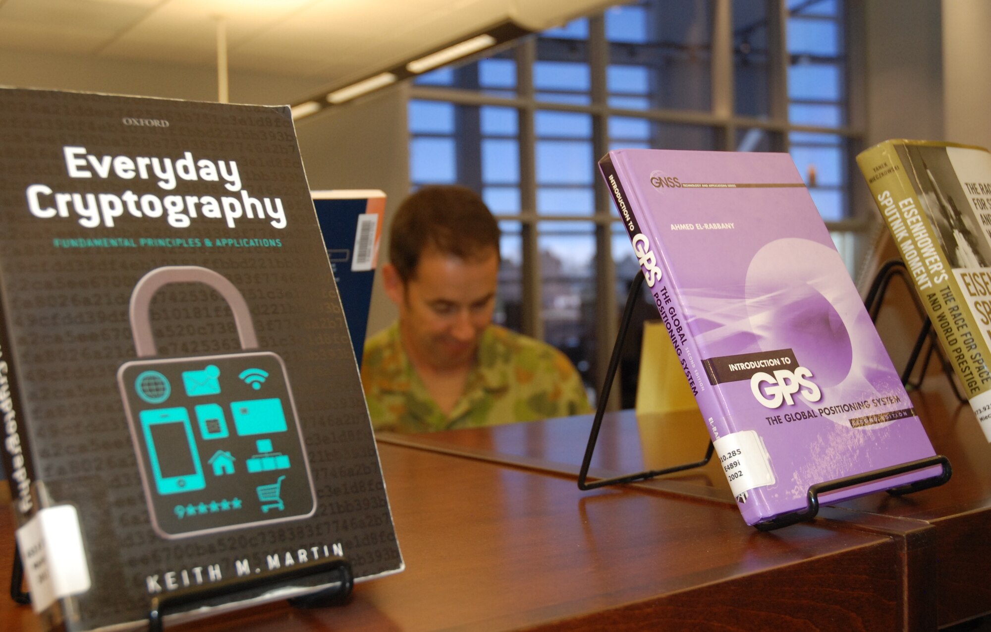 PETERSON AIR FORCE BASE, Colo. -- More than 2,700 books and a collection of the Jane’s Space System are amongst resources available to students and non-students, but check out privileges are limited to NSSI students. Lt. Col. Simon McDonald, deputy director for the Defence Space Coordinating Office, Strategy and Planning Branch of the Australian Army, browses the stacks in the background. (U.S. Air Force photo by Dave Smith)