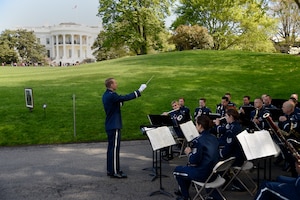 Capt. Joseph Hansen, U.S. Air Force Concert Band conductor and flight commander, leads the band during a White House Garden Tour Concert in Washington, D.C., April 26, 2015. Two weekends a year, visitors can listen to music while viewing the South Lawn and the gardens of the White House. (U.S. Air Force photo/Airman 1st Class Ryan J. Sonnier)