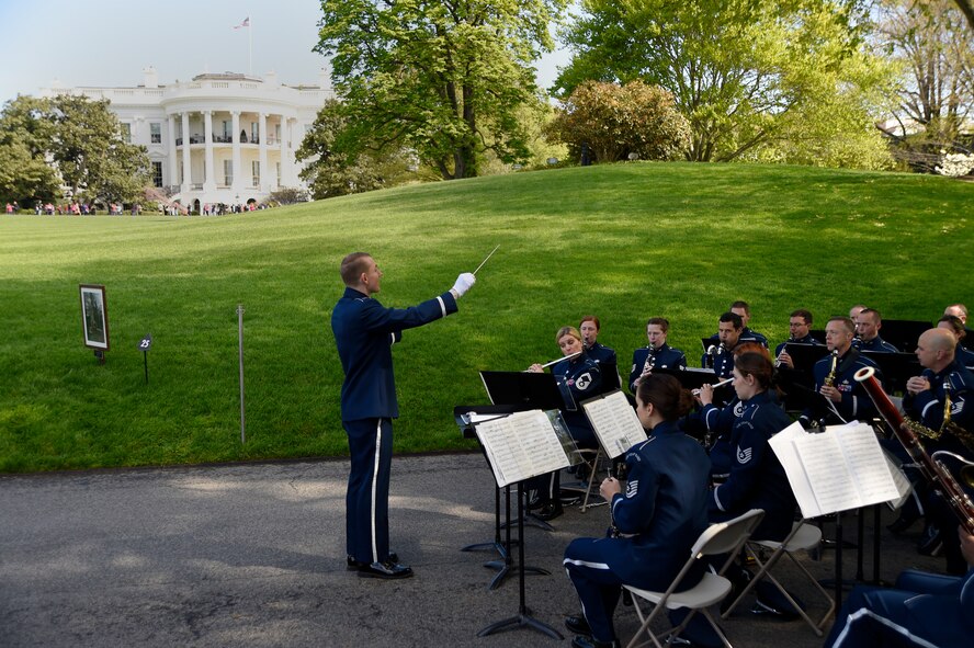 Capt. Joseph Hansen, U.S. Air Force Concert Band conductor and flight commander, leads the band during a White House Garden Tour Concert in Washington, D.C., April 26, 2015. Two weekends a year, visitors can listen to music while viewing the South Lawn and the gardens of the White House. (U.S. Air Force photo/Airman 1st Class Ryan J. Sonnier)