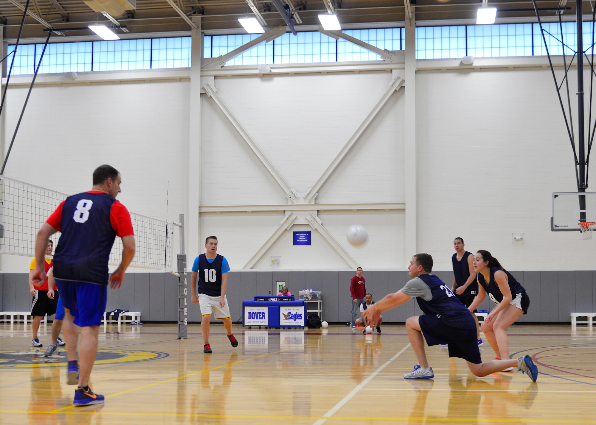 Andrew Muench, 9th Airlift Squadron, digs a serve from the 3d Airlift Squadron/436th Operations Support Squadron team during an intramural volleyball game April 23, 2015, at the fitness center on Dover Air Force Base, Del. The 9th AS swept the match 25-18 and 25-23. (U.S. Air Force photo/Airman 1st Class William Johnson)